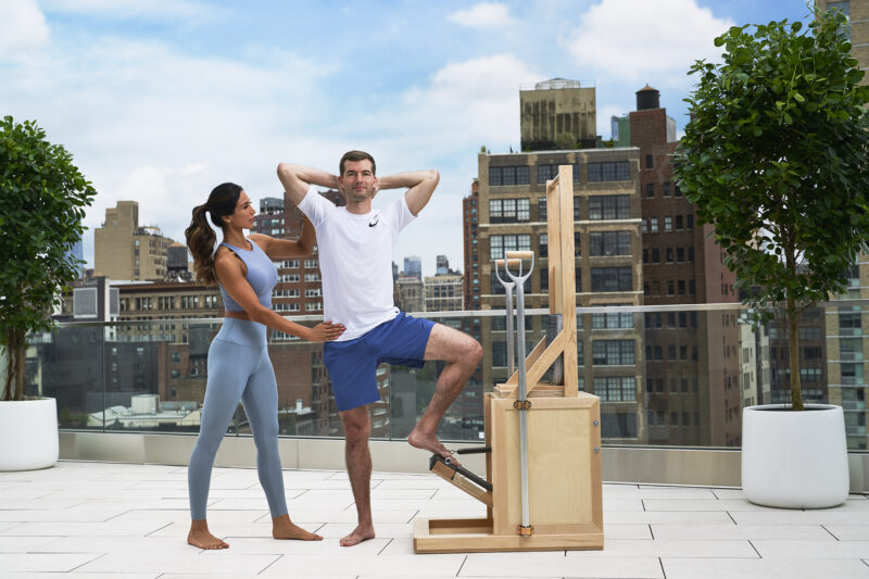 A lady trainer training the young man